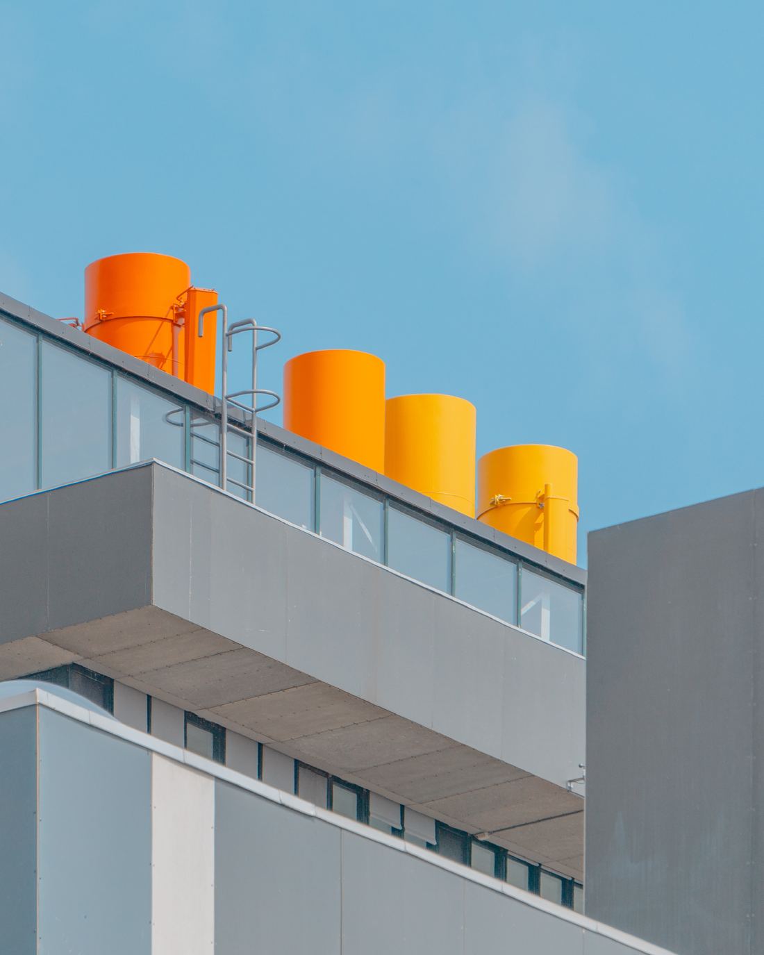 Estructuras naranja y amarillo sobre un edificio